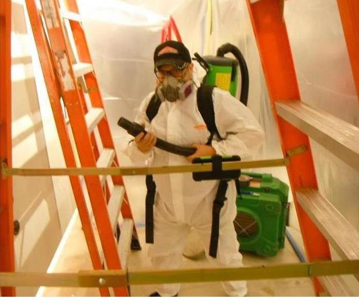 SERVPRO Employee in PPE Setting Up Containment for Mold Remediation
