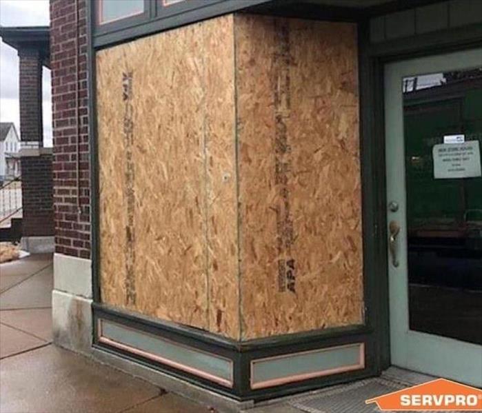 A business is boarded up after a storm 