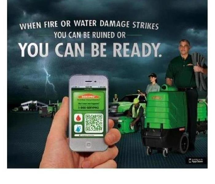 Hand holding up cell phone displaying SERVPRO's commercial Emergency Ready Profile app